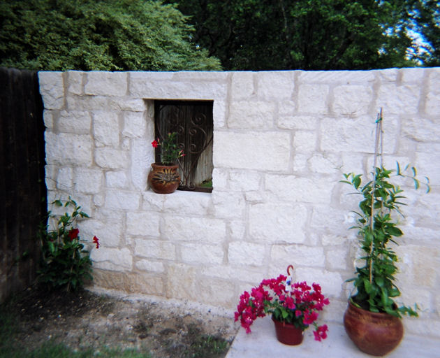 custom stone wall with archway - mediterrania iron